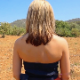 A blonde woman takes a long, firm shit at an outdoor location that appears warm and arid. Presented in 720P HD quality. About 2 minutes.